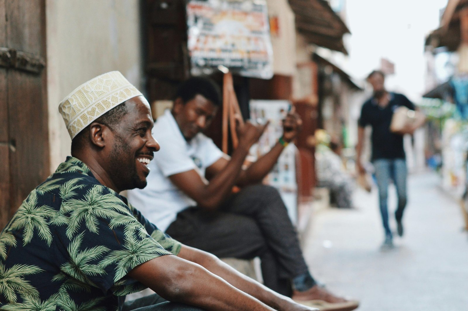 Casual street scene in Zanzibar City with men enjoying the day. Capturing vibrant street life and culture.