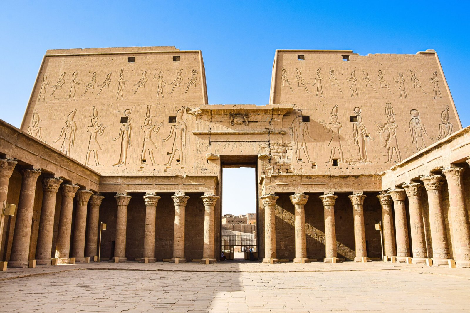Explore the historic grandeur of ancient Egyptian ruins with towering columns and intricate carvings.